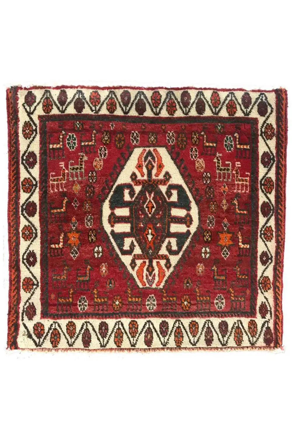 Square rug with a red pattern, white border tape, and fringes
