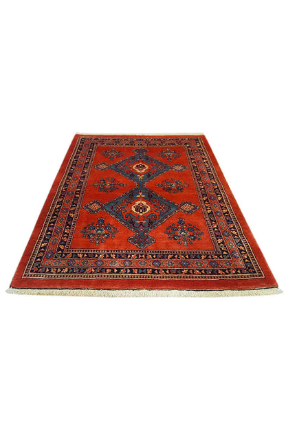 Red and blue rectangular rug with a central medallion and border pattern
