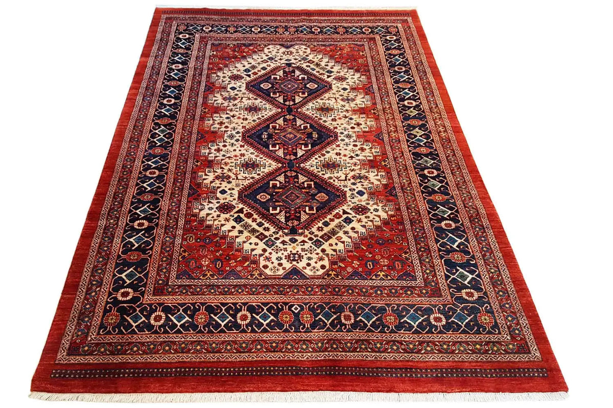 Rectangular oriental rug with a red ground, blue border pattern, and medallion