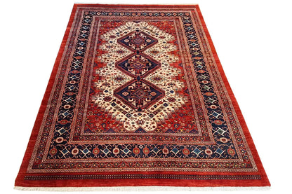 Rectangular oriental rug with a red ground, blue border pattern, and medallion