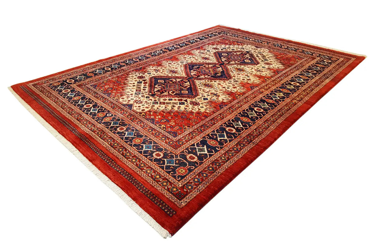 Rectangular Oriental rug with a red background, white and blue ornaments, and medallions