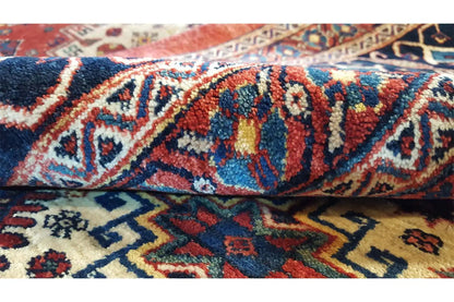 Detail of the oriental rug: knotted ornamental pattern in blue, red, and cream