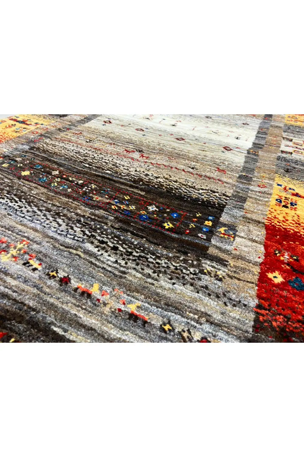 Gabbeh rug detail: Gray ornamental band with red, yellow, and blue accents