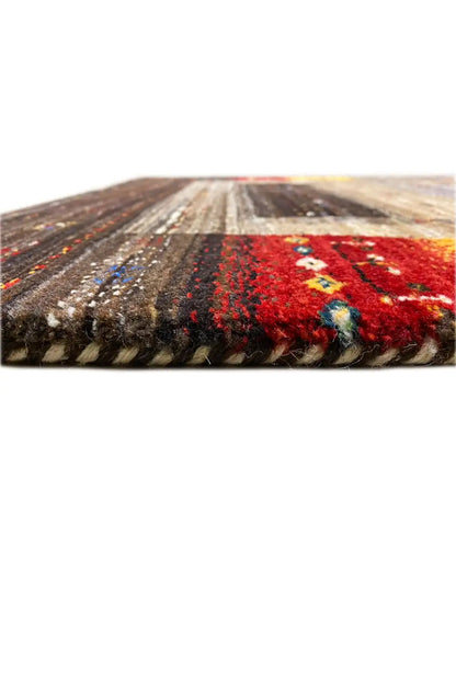Gabbeh rug (136x68 cm) close-up: soft fibers, reddish-brown pattern in the pile