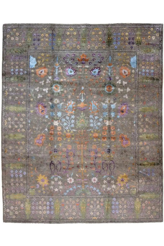Designer rug with a gray background, central medallion, and colorful floral vine border