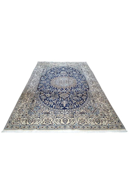 Beige oriental rug with a blue medallion pattern and wide border decoration.