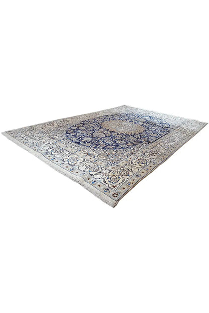 Corner view: flat Oriental rug with a blue medallion and surrounding ornaments.