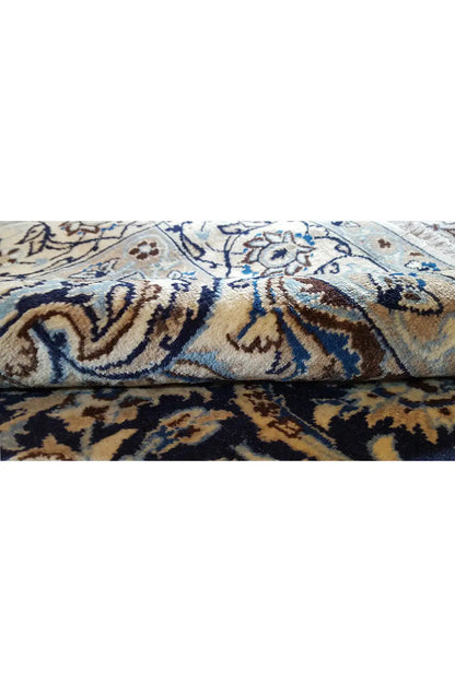 Close-up: ornamental carpet pattern in blue and beige, with a visible pile texture.