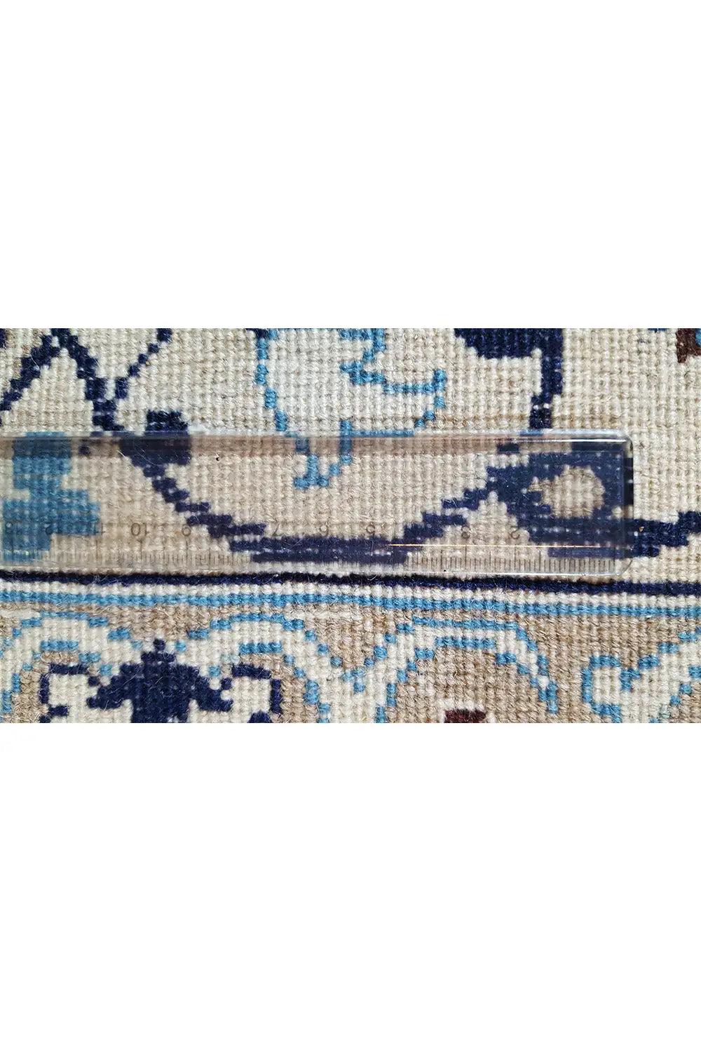 Pattern detail: blue embossed ornaments on a light background, fine woven texture.