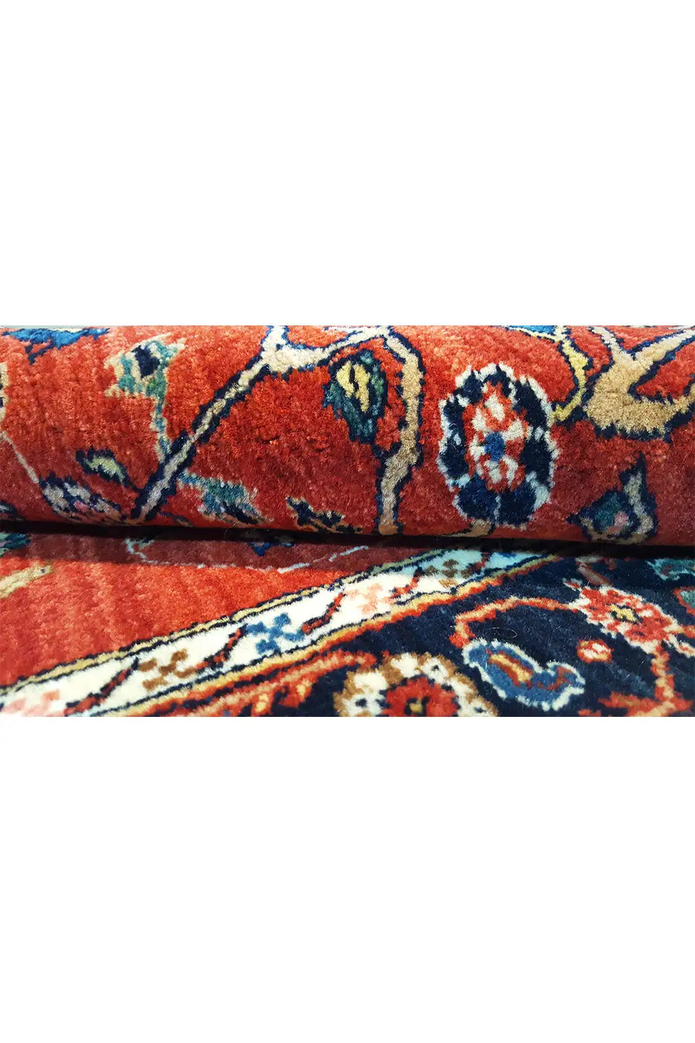 Carpet pile detail: red fabric with multicolored ornaments and border pattern