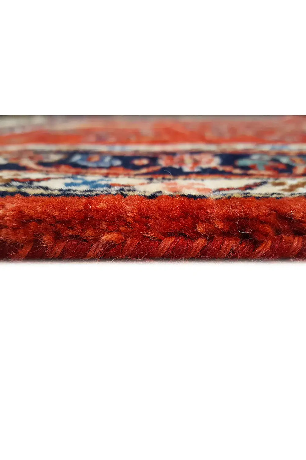 Carpet edge with fringe: red pile and contrasting border pattern