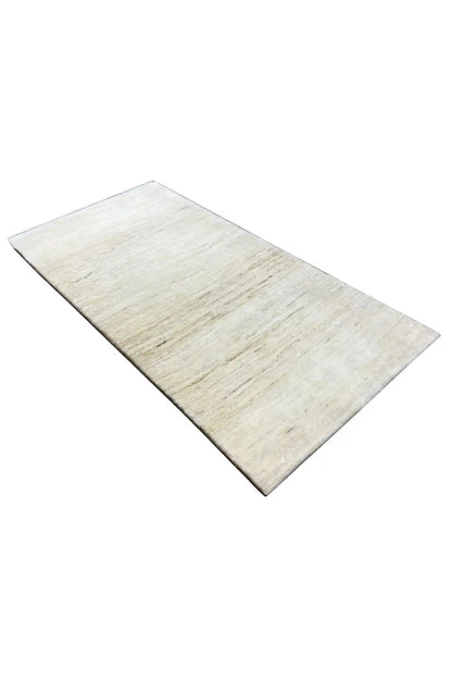 Gabbeh rug in light beige, subtle color gradients, diagonally from above