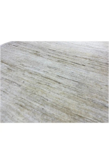 Gabbeh rug detail: mottled texture with fine lines, light beige tones