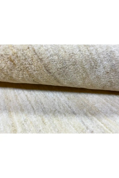 Gabbeh rug detail: raised pile edge, light beige appearance with darker fiber roots