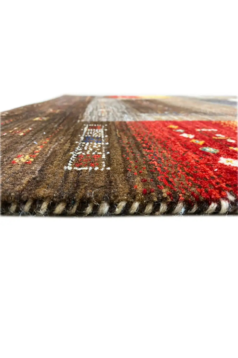 Gabbeh rug from above, thick pile pattern with red and brown areas
