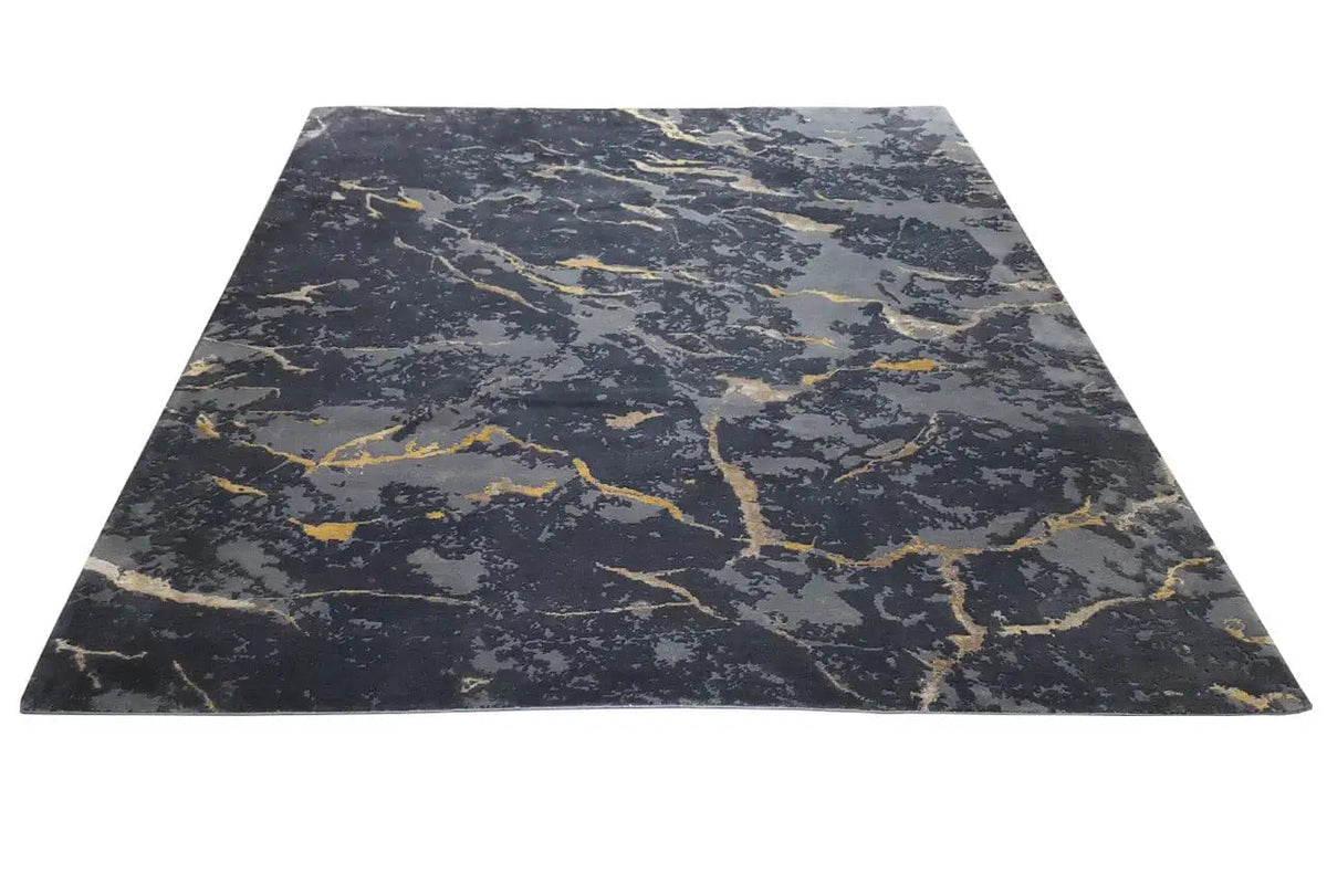 Rectangular rug in dark gray with yellowish marble details and veining