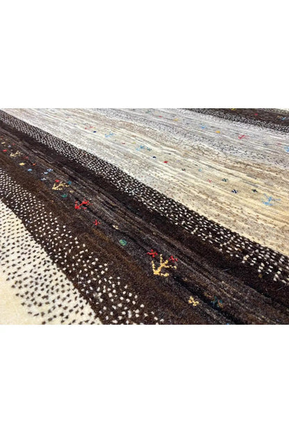 Gabbeh rug 122x116 cm close-up of the weave: dark stripe with colorful dots