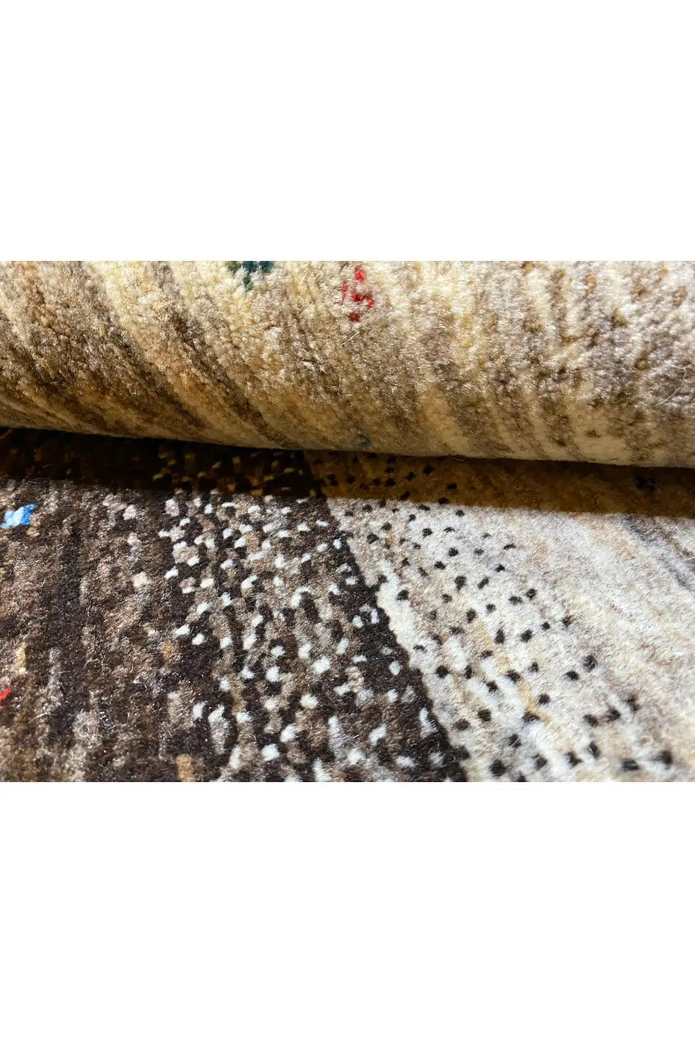 Gabbeh rug 122x116 cm close-up: rolled pile with a beige and dark pattern