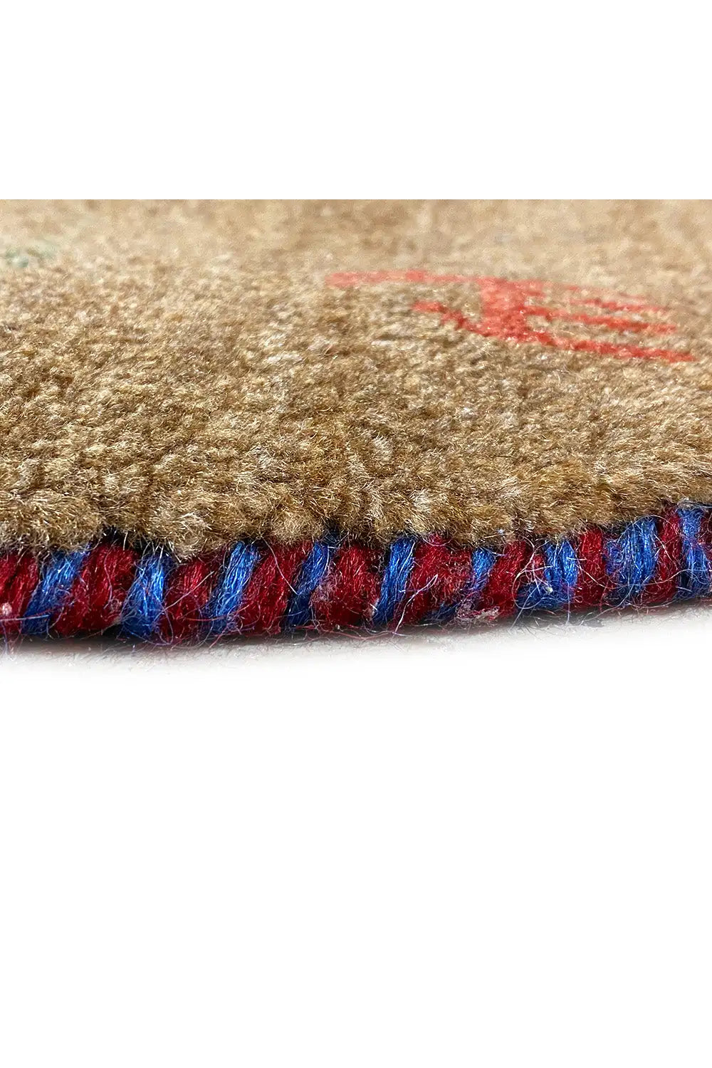 Close-up: Gabbeh rug edge with a colorful fringe band in blue and red