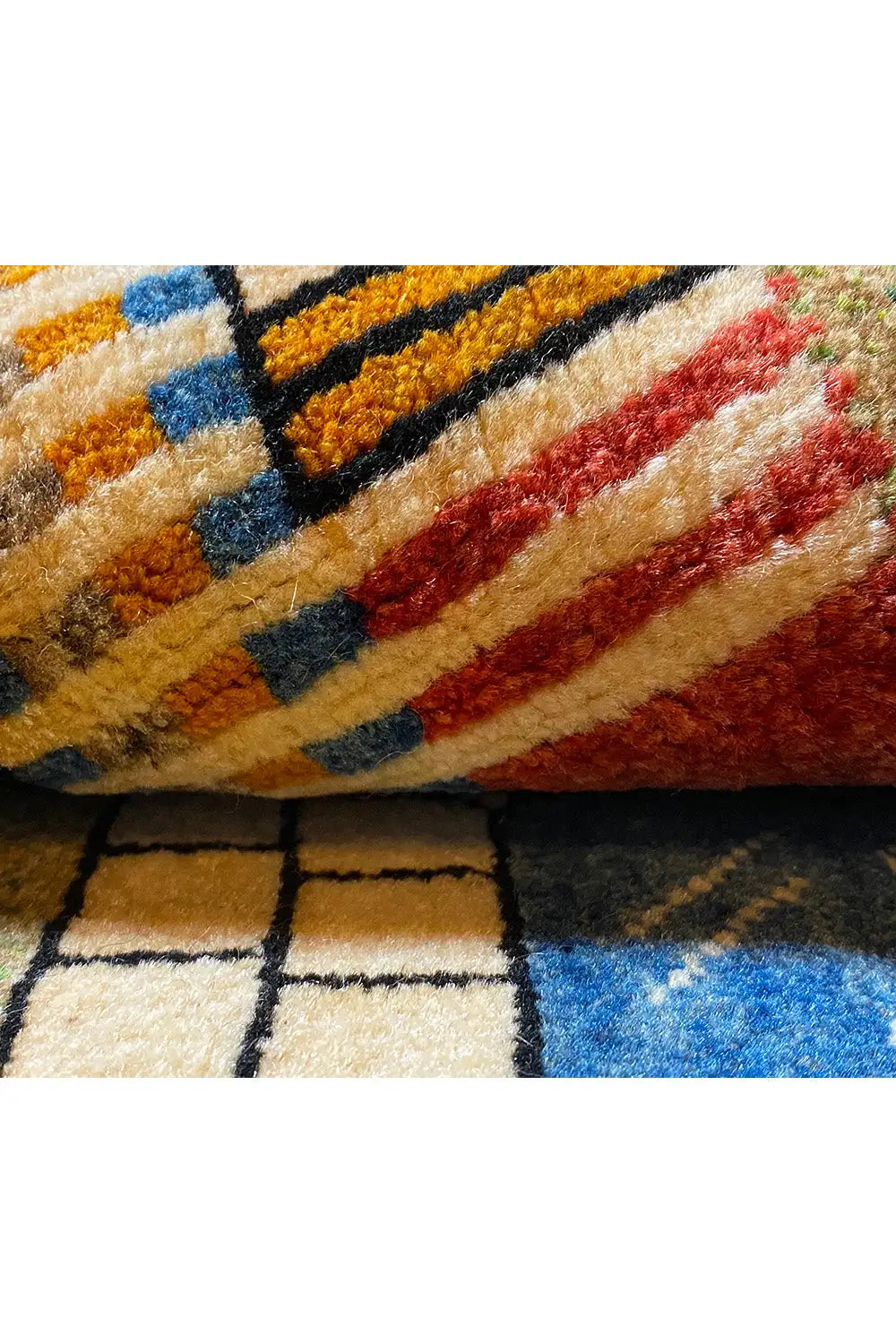 Close-up: woven patterned stripe design in blue, red, black, and beige