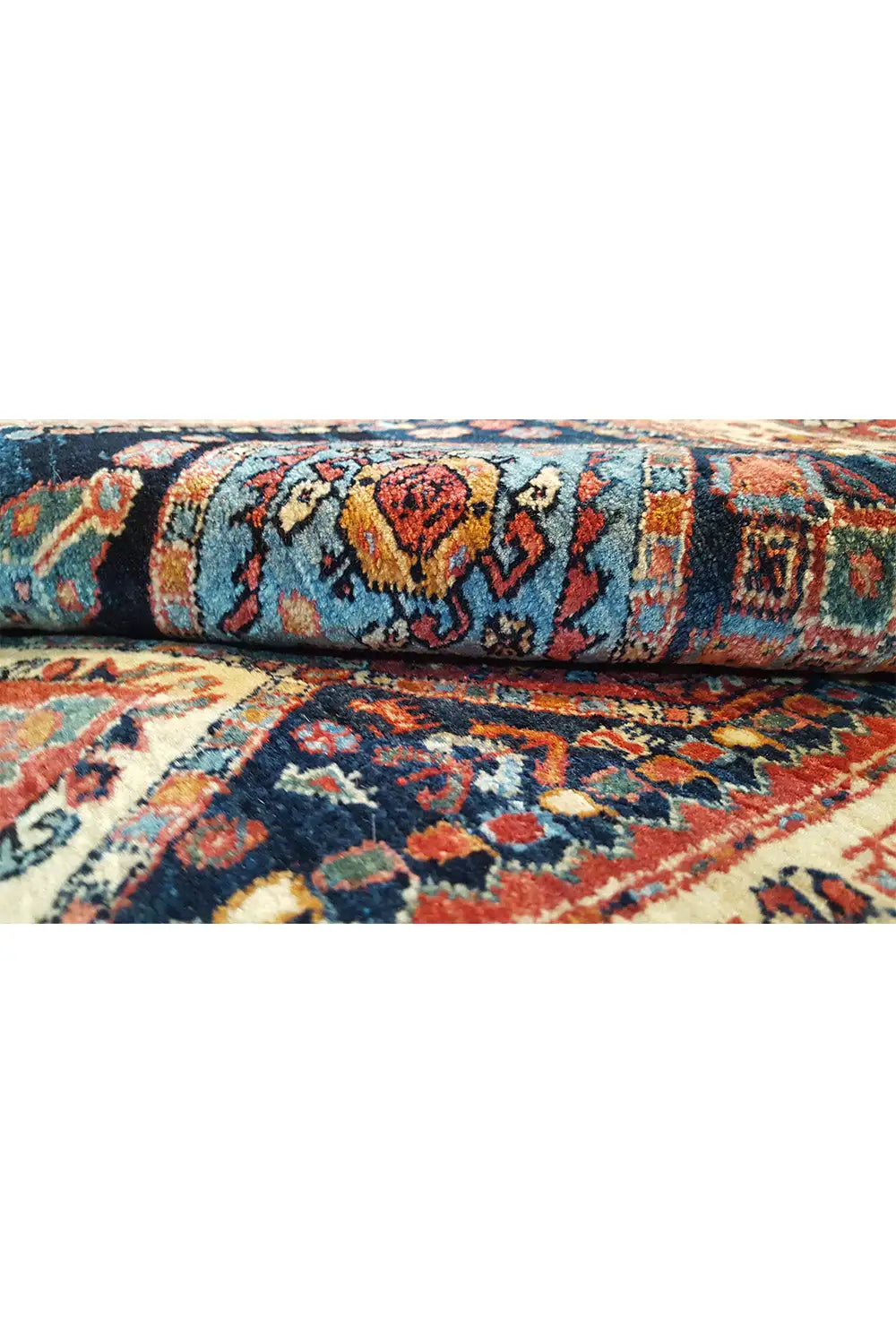 Carpet edge with dense pile and a striped border pattern in blue, red, and beige