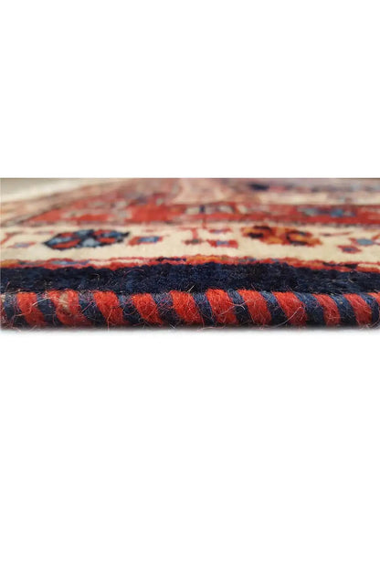 Close-up: carpet edge with dense, multicolored pile and woven border pattern