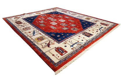 Rug in red, blue, and beige with a geometric center and decorative border design