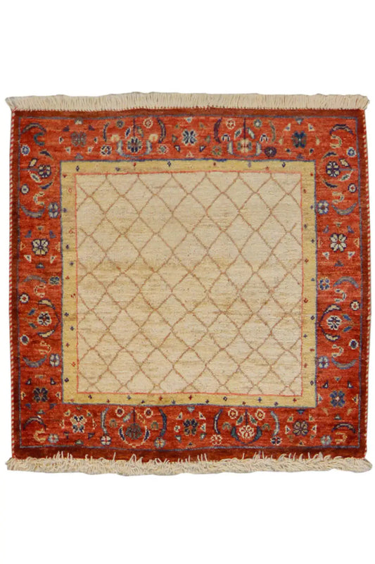 Square rug 62x62 cm with a beige central square, red ornamental border, and fringe.