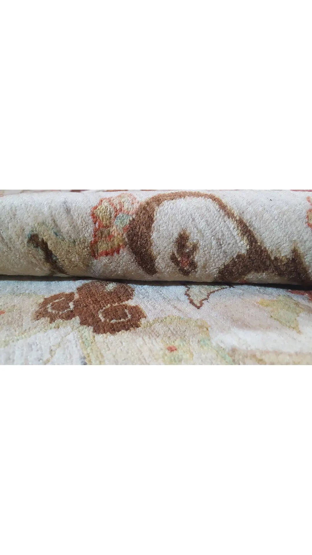 Rug surface with a beige pile and multicolored floral patterns