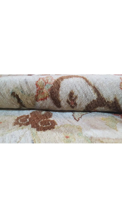 Rug surface with a beige pile and multicolored floral patterns