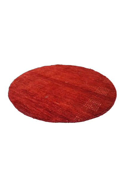 Round Gabbeh rug “Lori” (86x86 cm) in red, slightly angled view