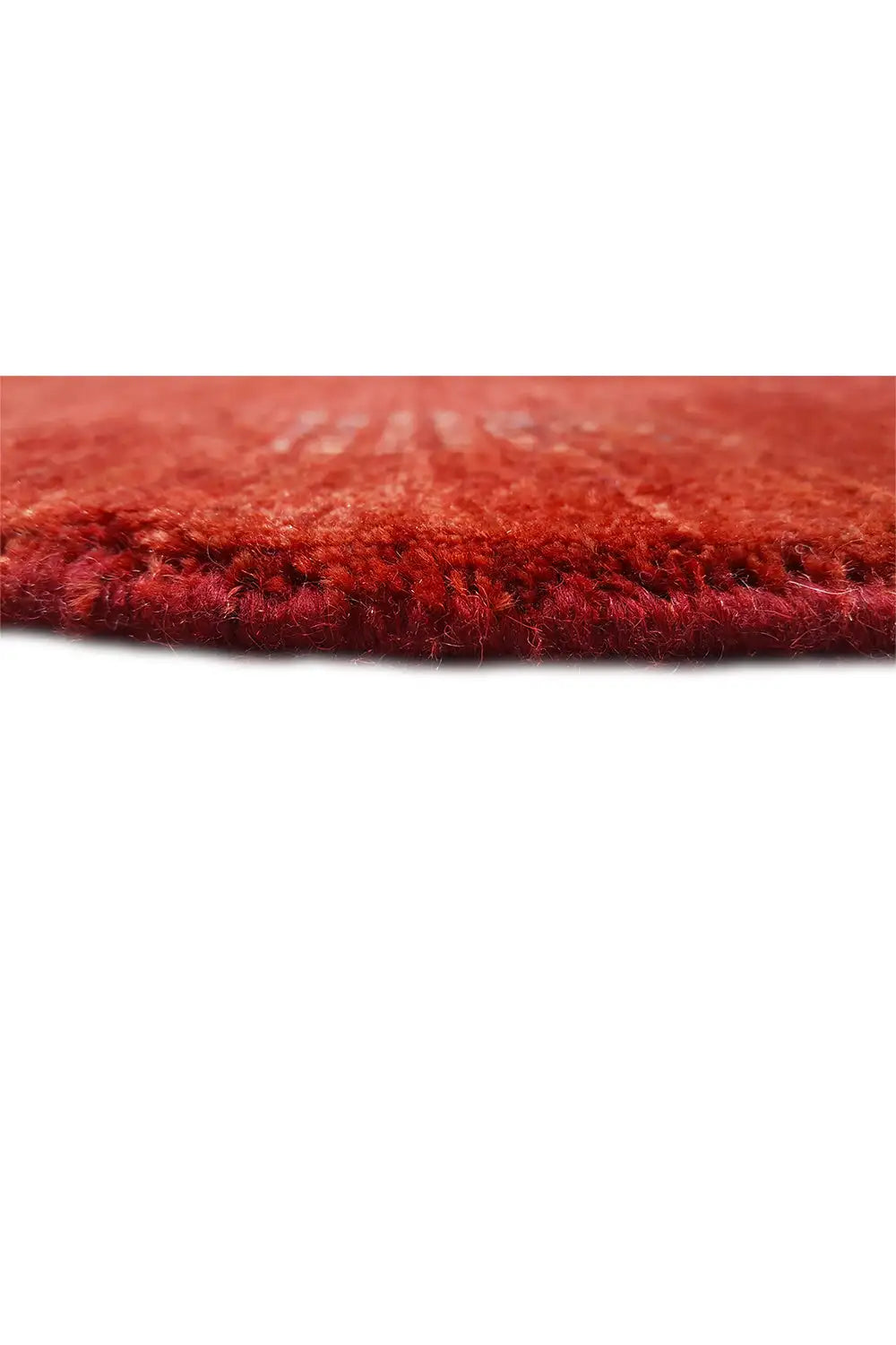 Side close-up: red Gabbeh rug with a dense, deep pile