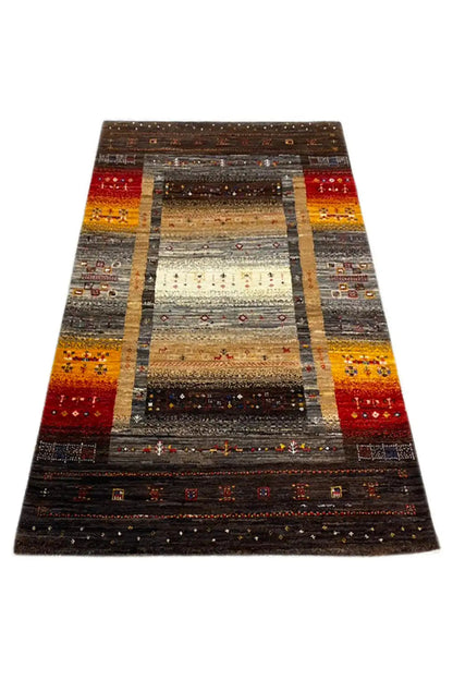 Gabbeh rug 130x83 cm, viewed diagonally from above: brown, red, yellow, and gray central stripe