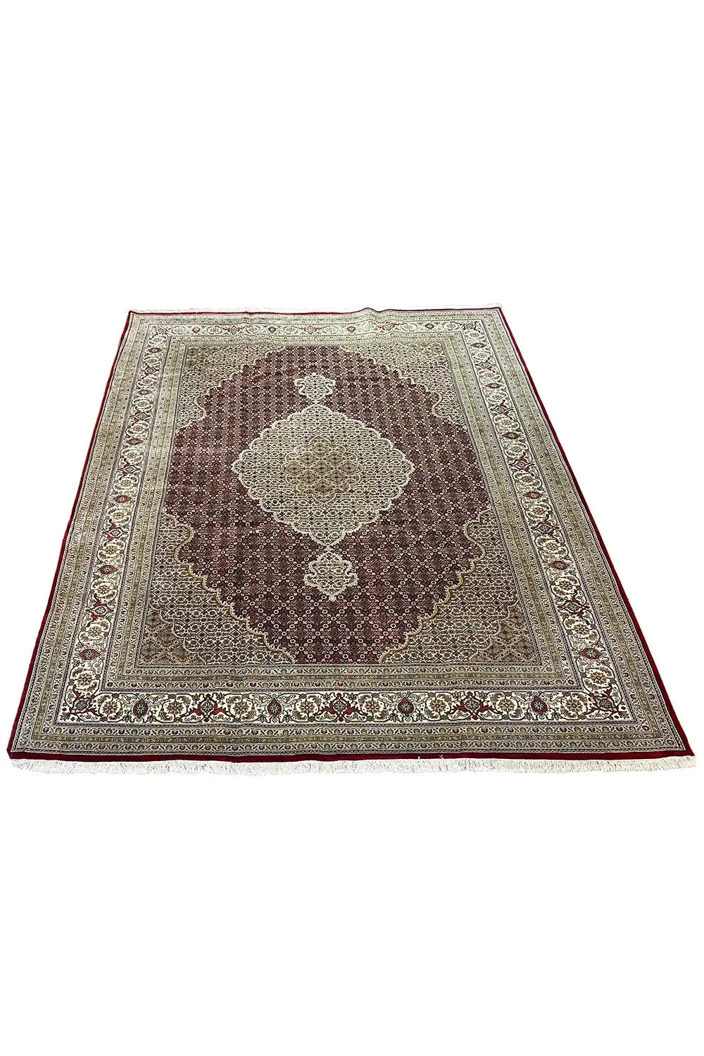 Indo Täbriz rug, angled view: central medallion with ornaments, cream and brown tones