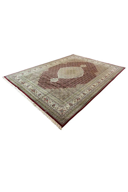 Indo Tabriz rug in a diamond pattern, with a medallion motif and border in cream, brown, and dark red