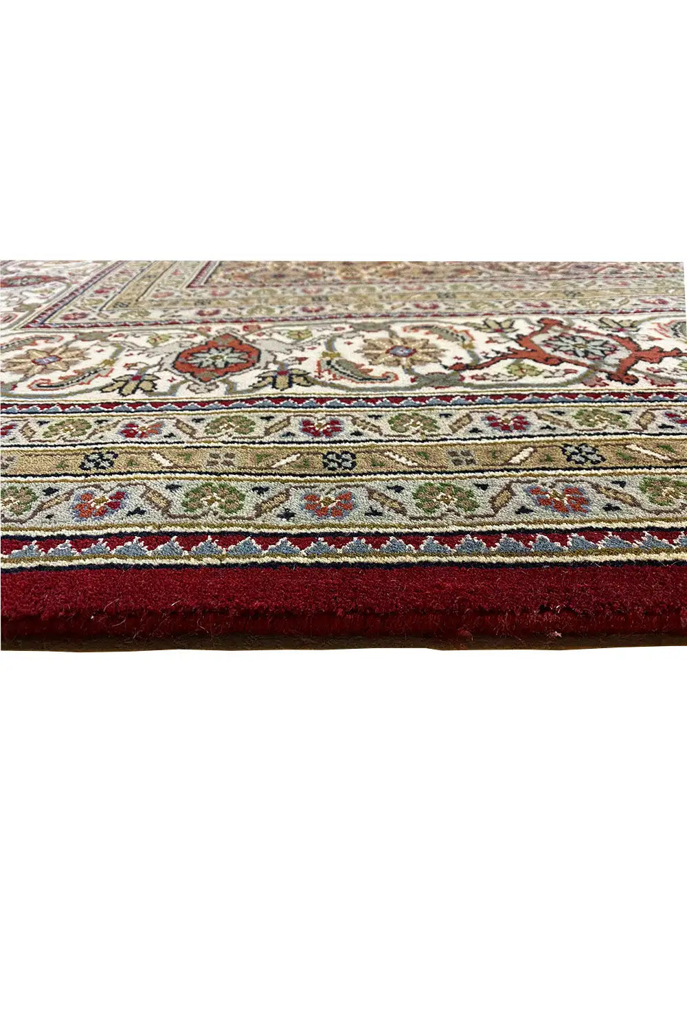 Indo Tabriz carpet detail at the edge: decorative border with fringes, multicolored on a light background