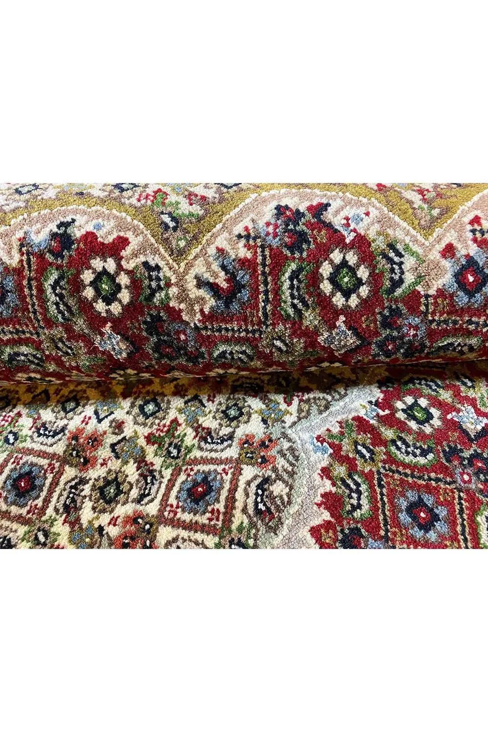 Indo Tabriz rug, close-up of the pattern: floral ornaments in red, blue, green, and cream