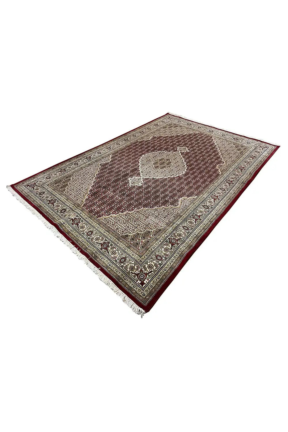 Carpet at an angle: reddish-brown center, beige border, and small ornaments