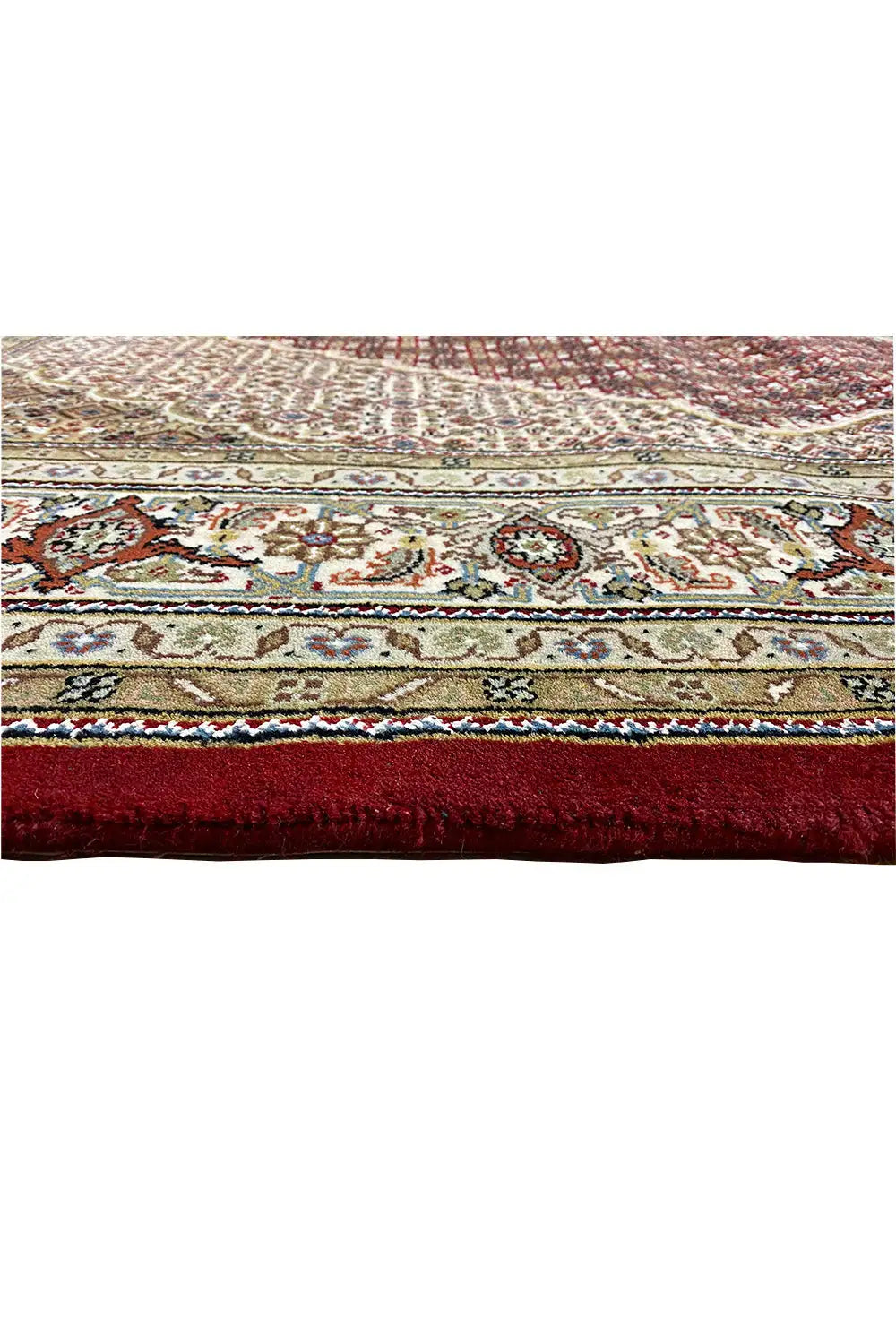 Carpet detail at the edge with a border, colorful patterns, and a narrow fringe trim