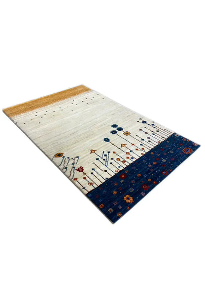 Gabbeh rug 123x77 cm, angled, light field with vine ornaments and blue border.strip