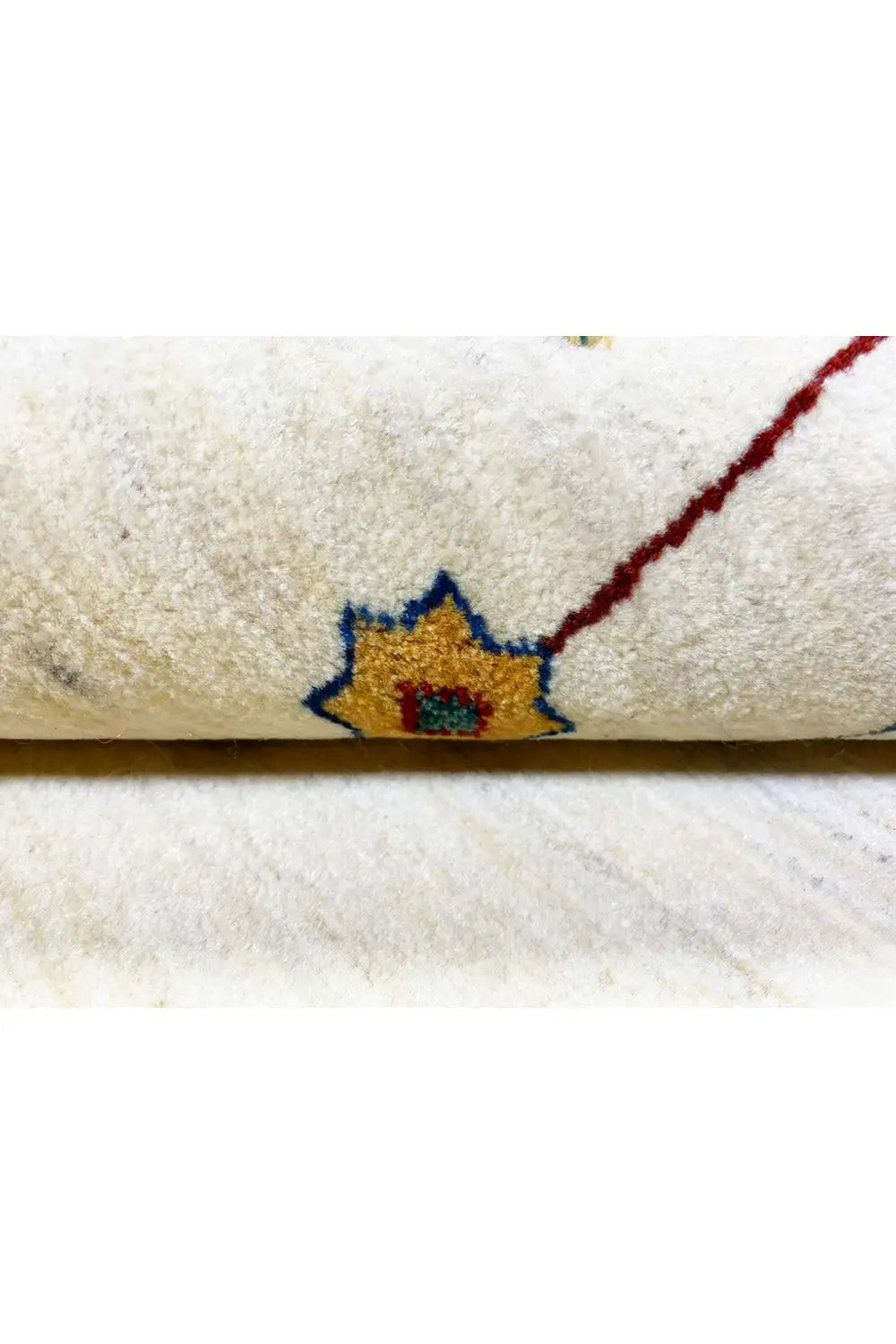 Gabbeh rug 123x77 cm close-up: dense pile and embroidery-like floral symbol