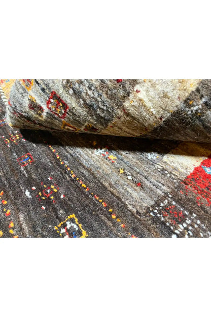 Close-up view of a rug surface with ornamental dots in gray, red, and blue