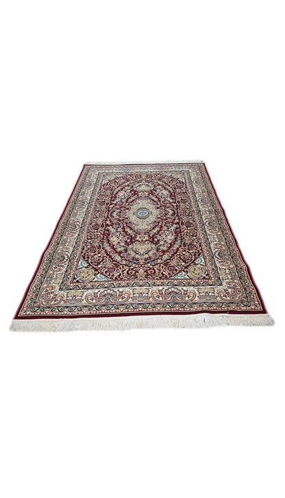 Machine-woven carpet spread out, red medallion pattern within a border frame