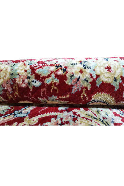 Carpet surface in detail: colorful ornamental design with red pile and bound edge