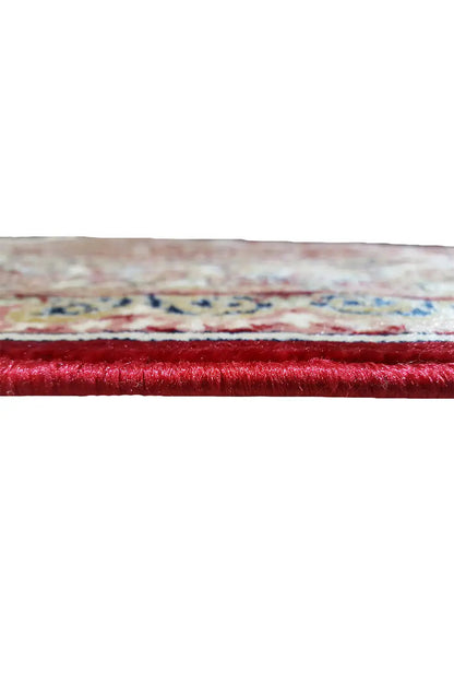 Carpet edge in detail: red pile with multicolored shading and hem
