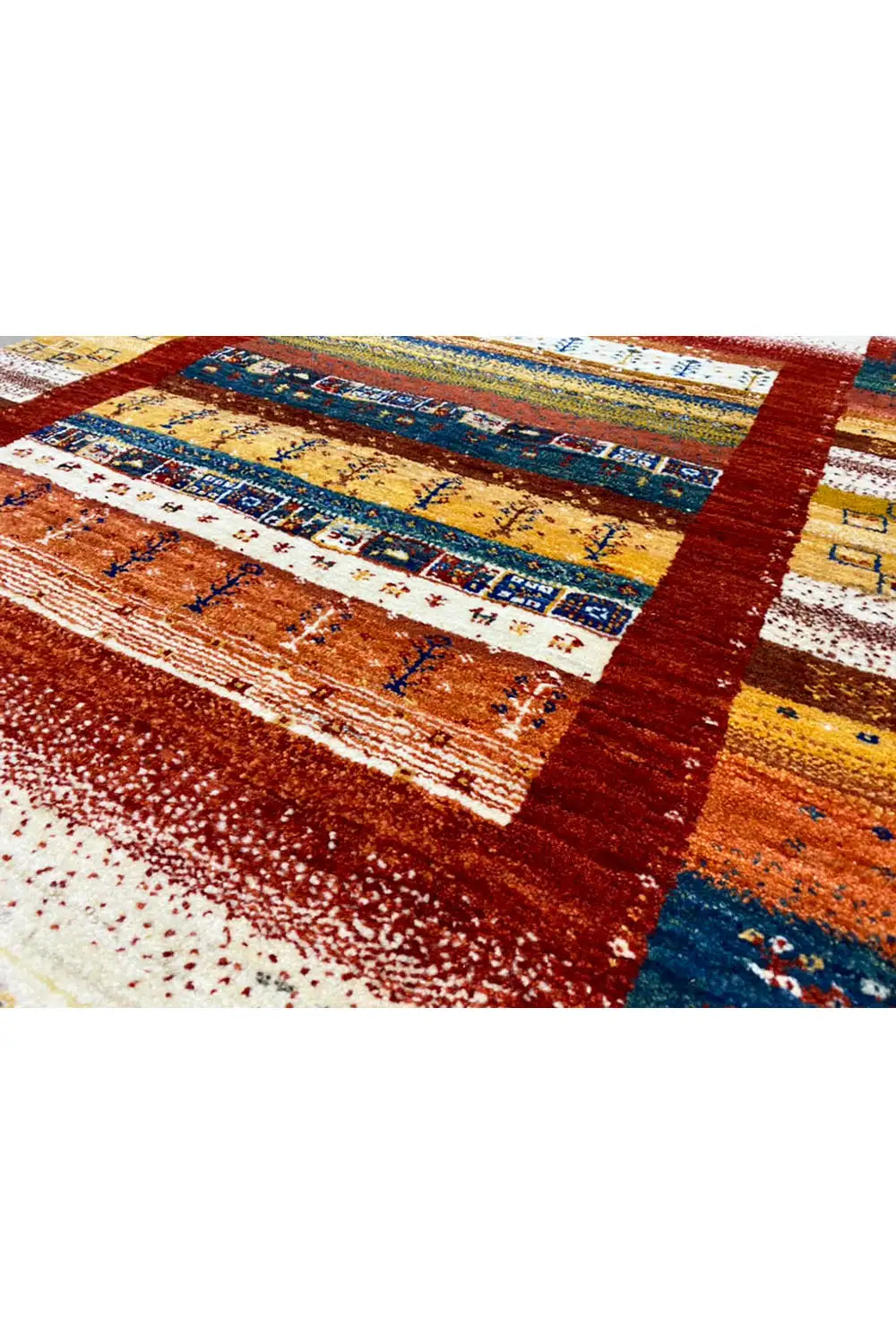 Gabbeh rug (140x97 cm) close-up: dense pattern in reddish brown, blue, and gold