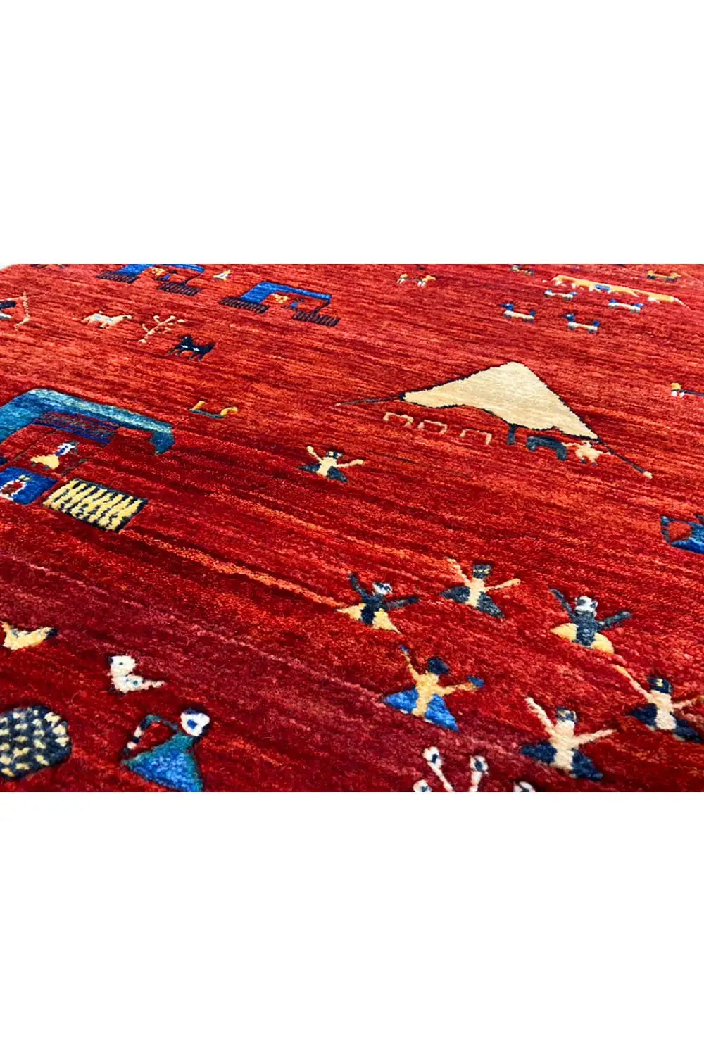 Gabbeh rug close-up: red weave with colorful figures and ornaments