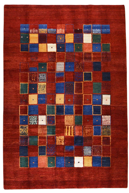 Gabbeh rug with a square patchwork pattern in shades of red, blue, and green