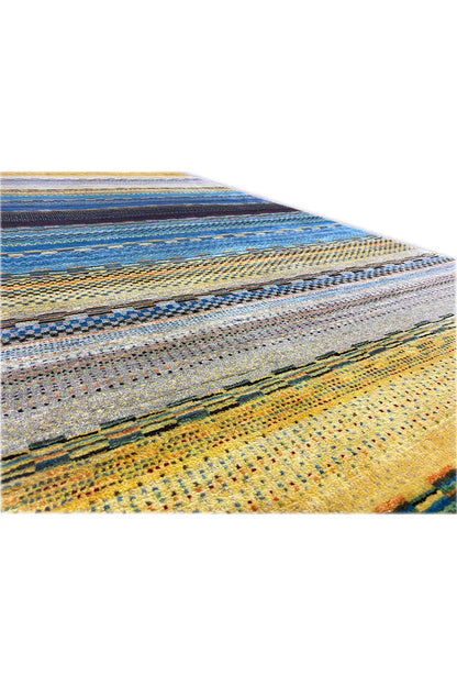 Corner of the Gabbeh rug with stripes in blue, yellow, and gray