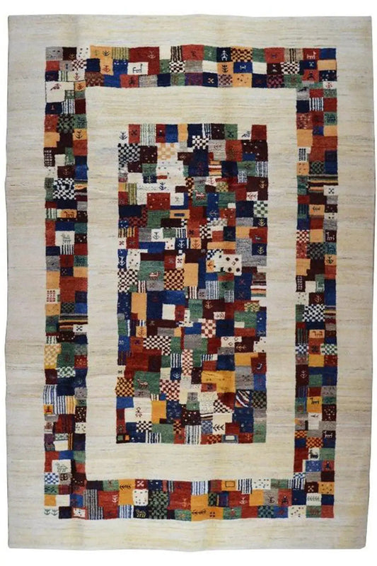 Rectangular Gabbeh rug with a central patchwork square pattern and colorful border